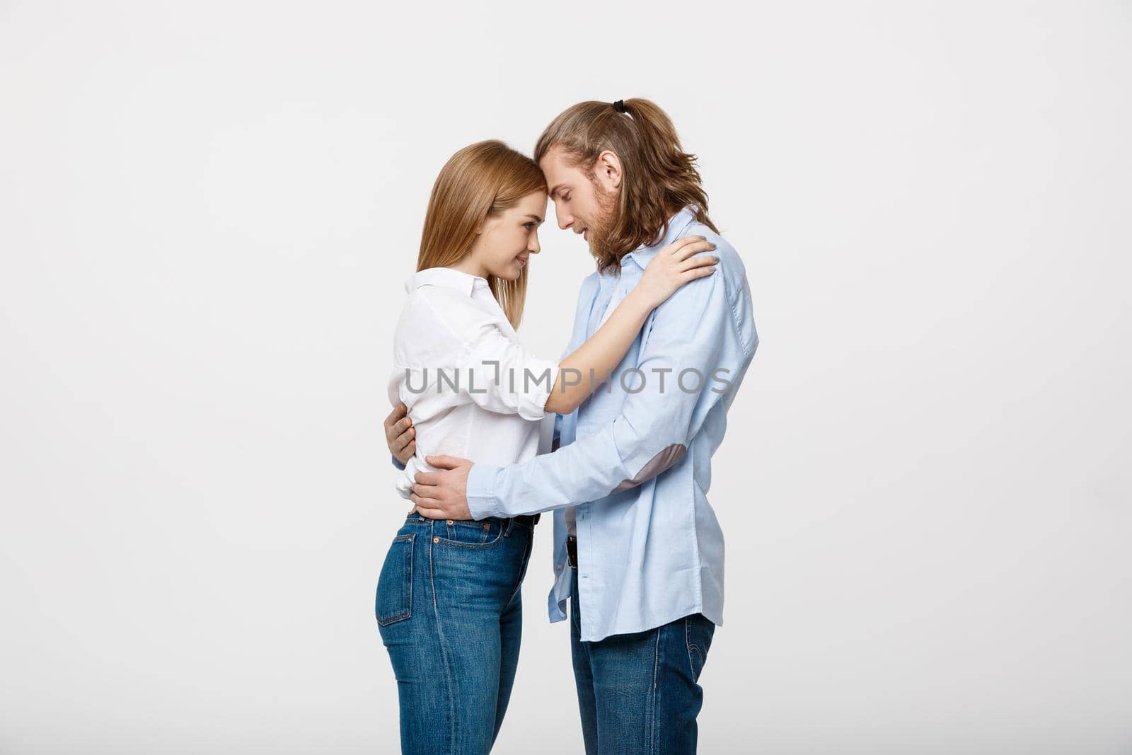 Young in love Couple Touching Foreheads and huging over isolated on white background.