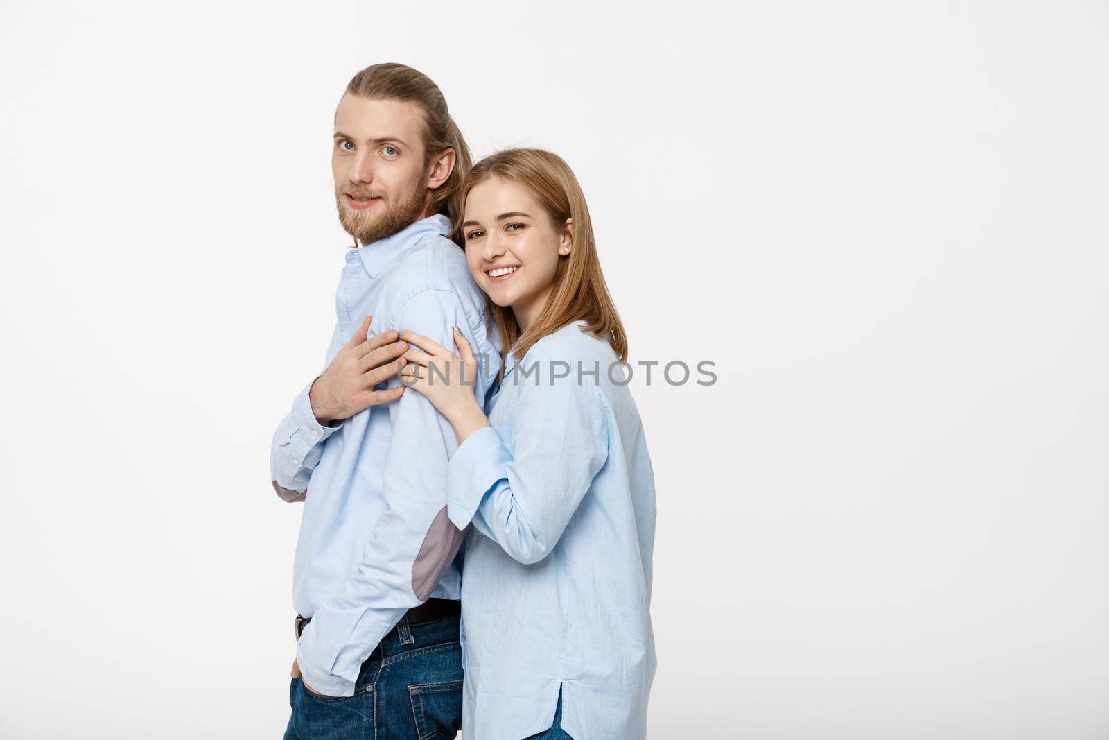 young attractive couple in blue shirt showing engaged ring