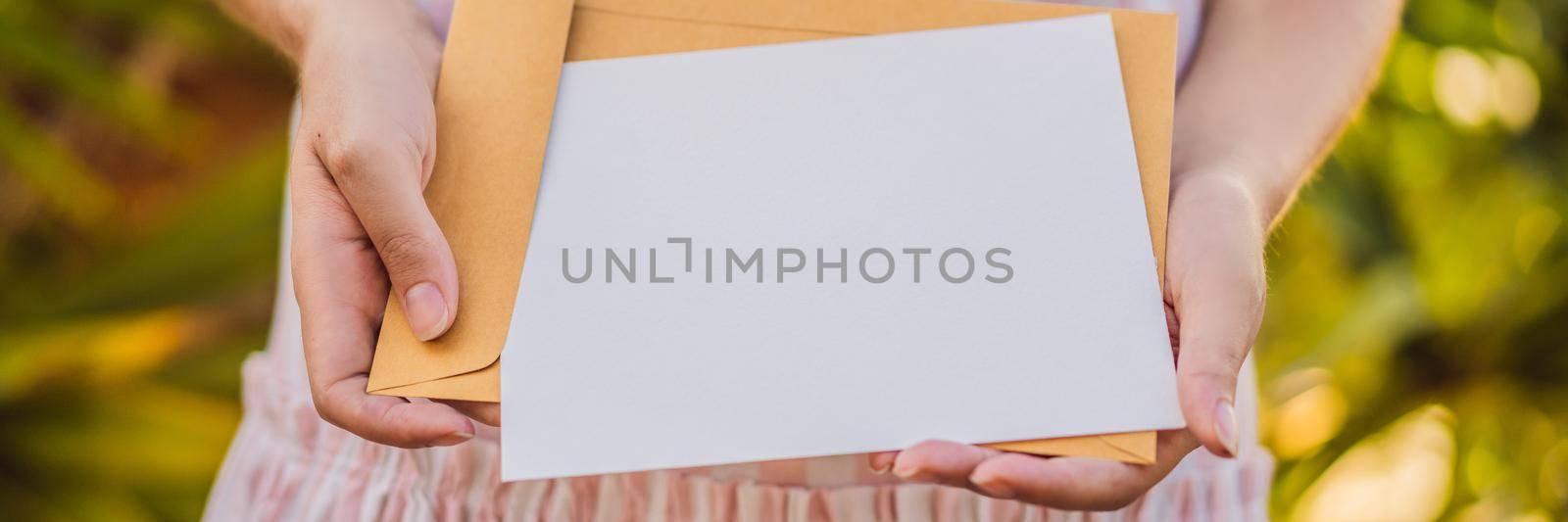 Women's hands in a tropical background holding a signboard mockup BANNER, LONG FORMAT