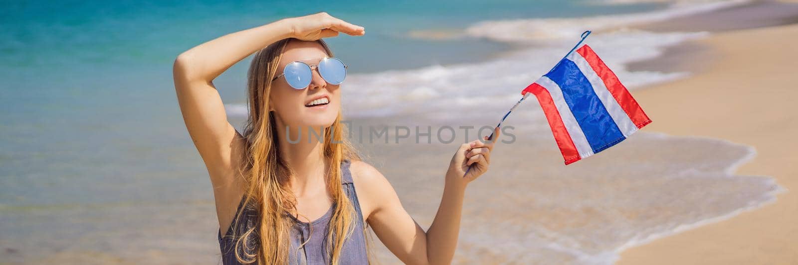 Happy woman having fun at the beach with Thailand flag. Beautiful girl enjoying travel to Asia BANNER, LONG FORMAT by galitskaya