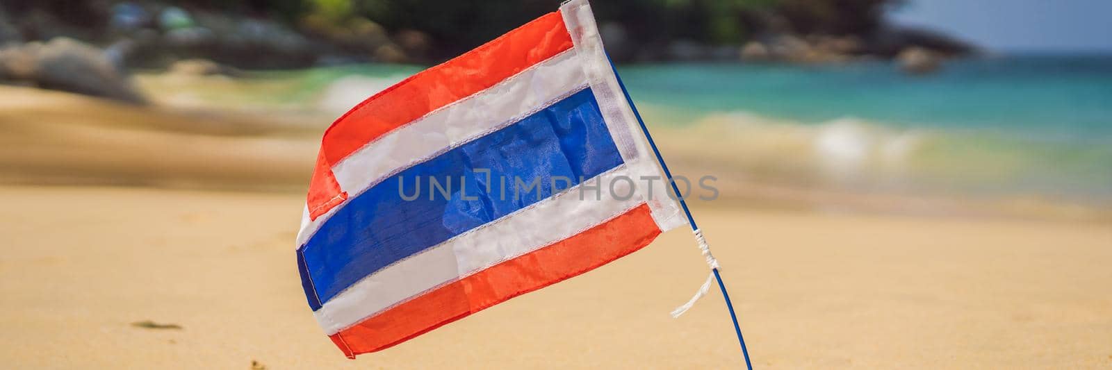 Waving Thailand flag in the sunny blue sky with summer beach background. Vacation theme, holiday concept. BANNER, LONG FORMAT