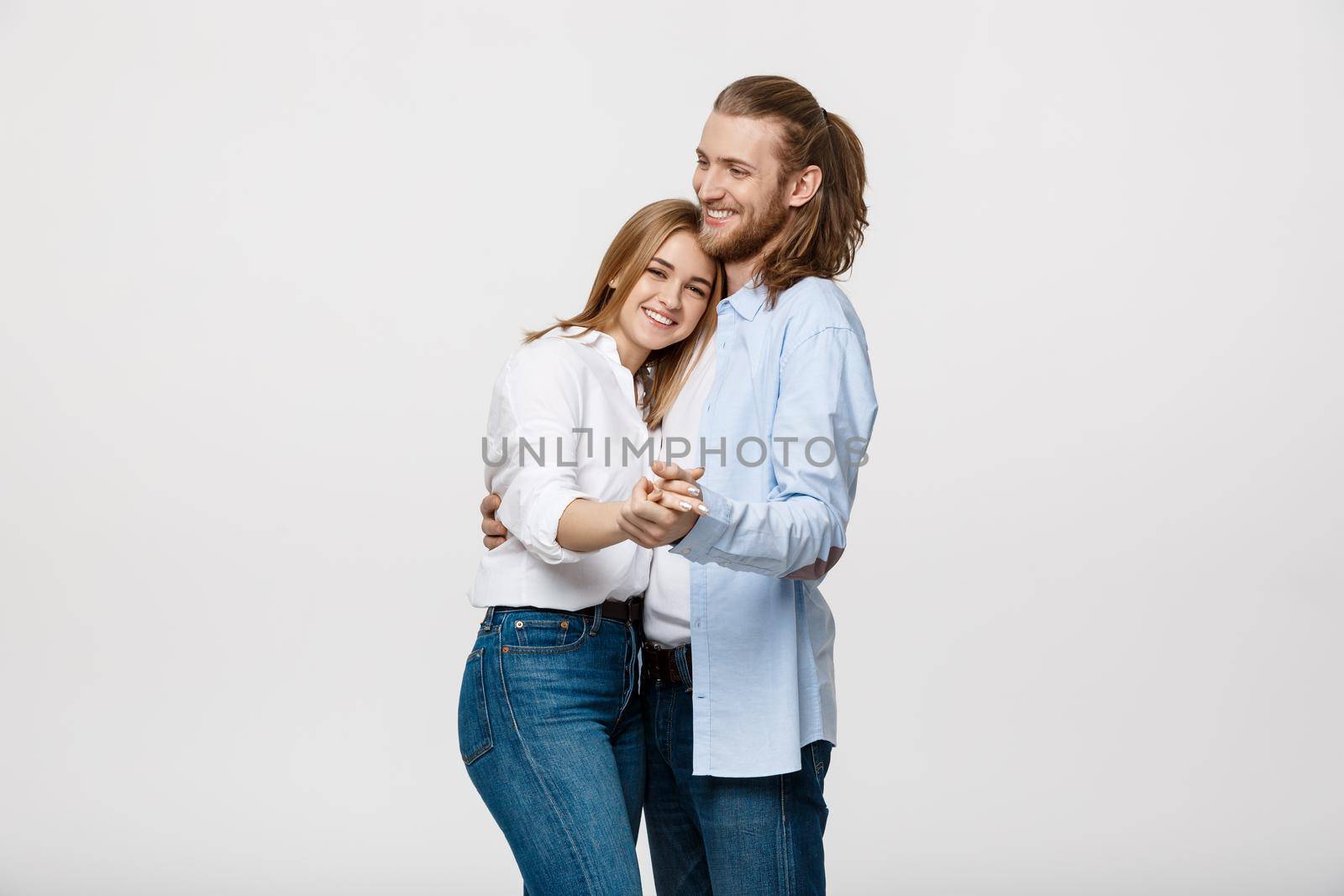 Young elegant couple in casual cloth dancing over Isolated on white studio background