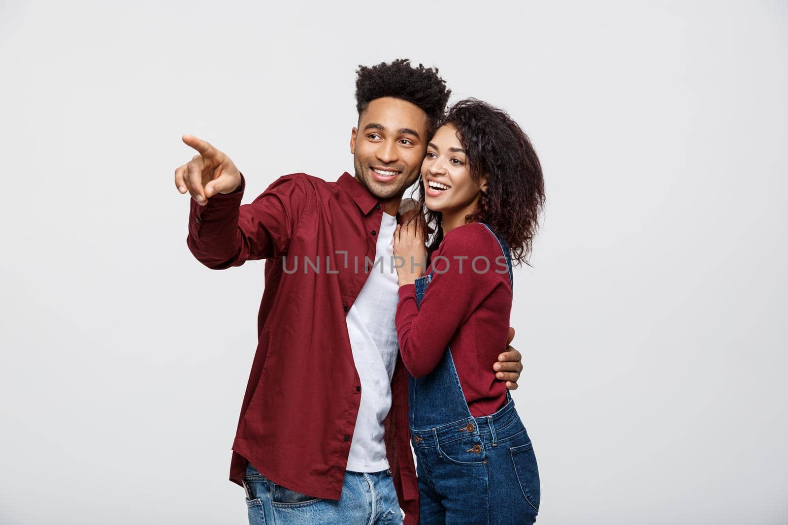 Young African American people in casual clothes looking away and point finger. isolated on white background by Benzoix