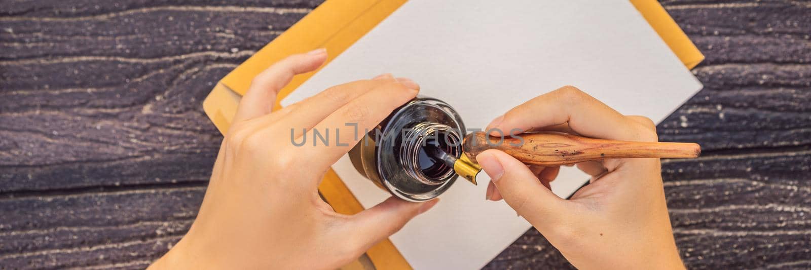 Women's hands in a wooden background holding a signboard, drawing block, paper, mockup BANNER, LONG FORMAT by galitskaya
