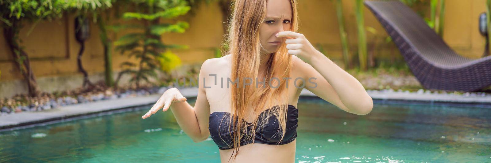 Young woman with disgust on his face pinches nose, something stinks, very bad smell in swimming pool because of pool chemicals. Negative emotion facial expression. BANNER, LONG FORMAT