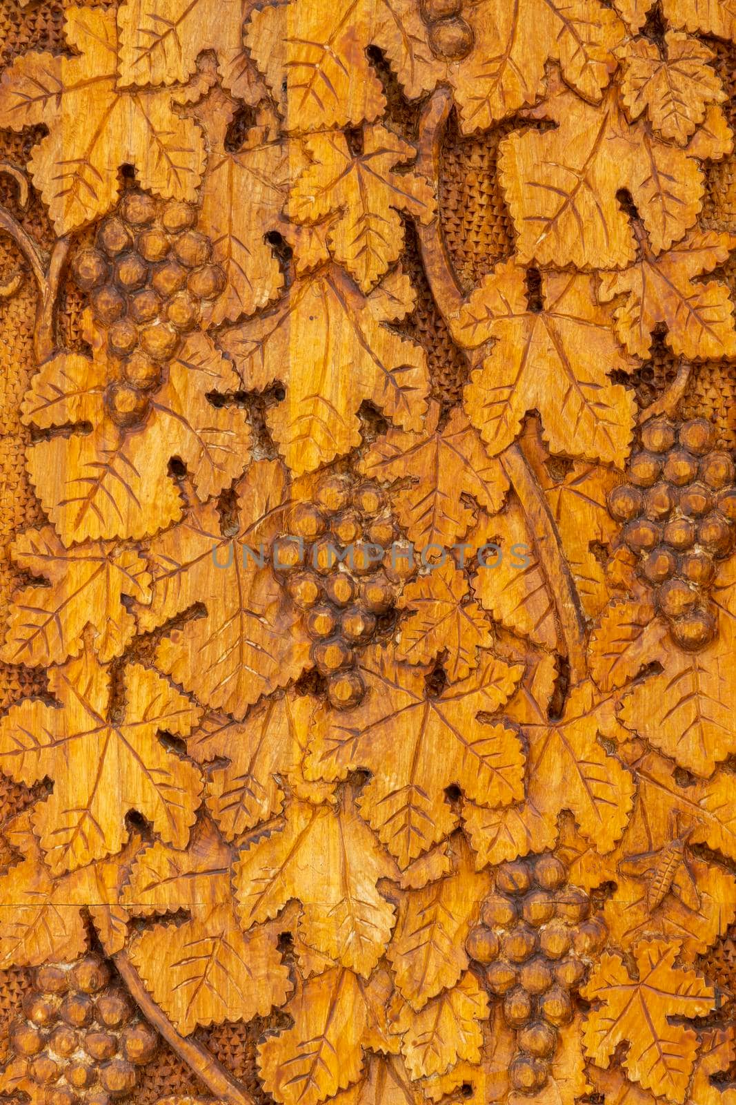 wood carving of grape leaves and grapes