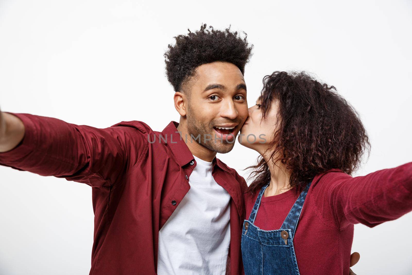 Close up attractive African American couple making a selfie with cute gesture. by Benzoix