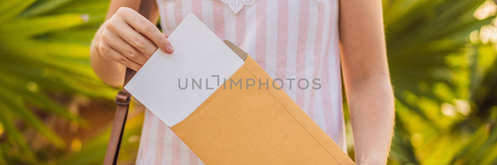 Women's hands in a tropical background holding a signboard mockup BANNER, LONG FORMAT