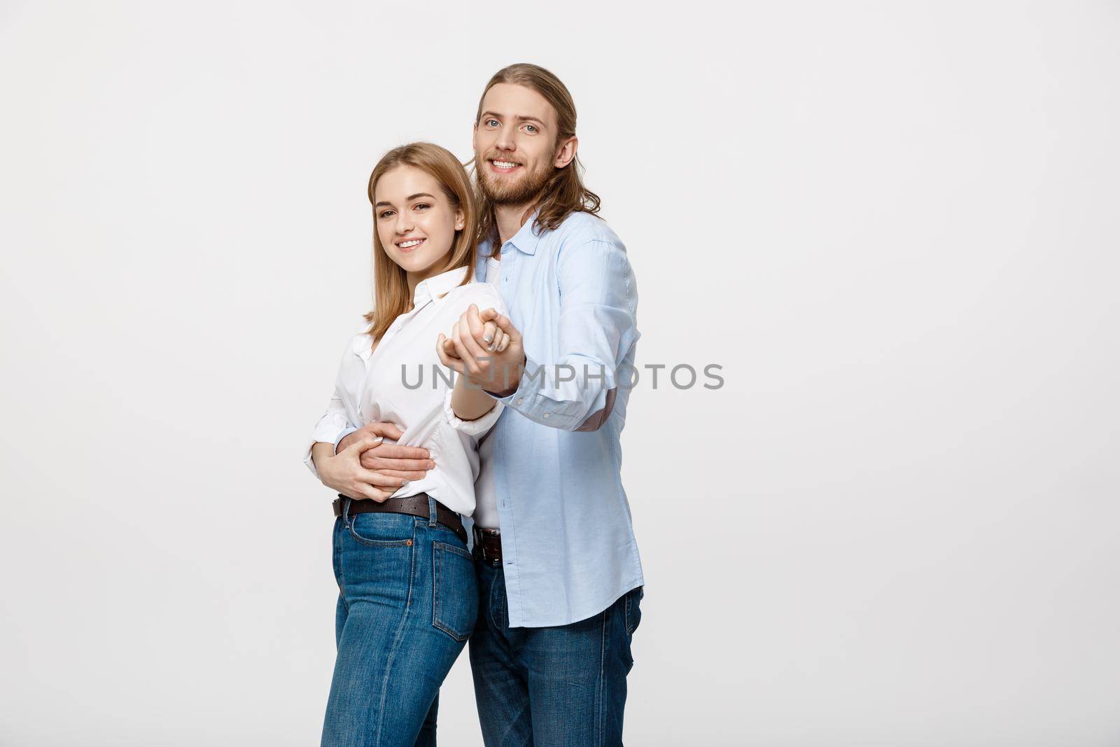 Young elegant couple in casual cloth dancing over Isolated on white studio background