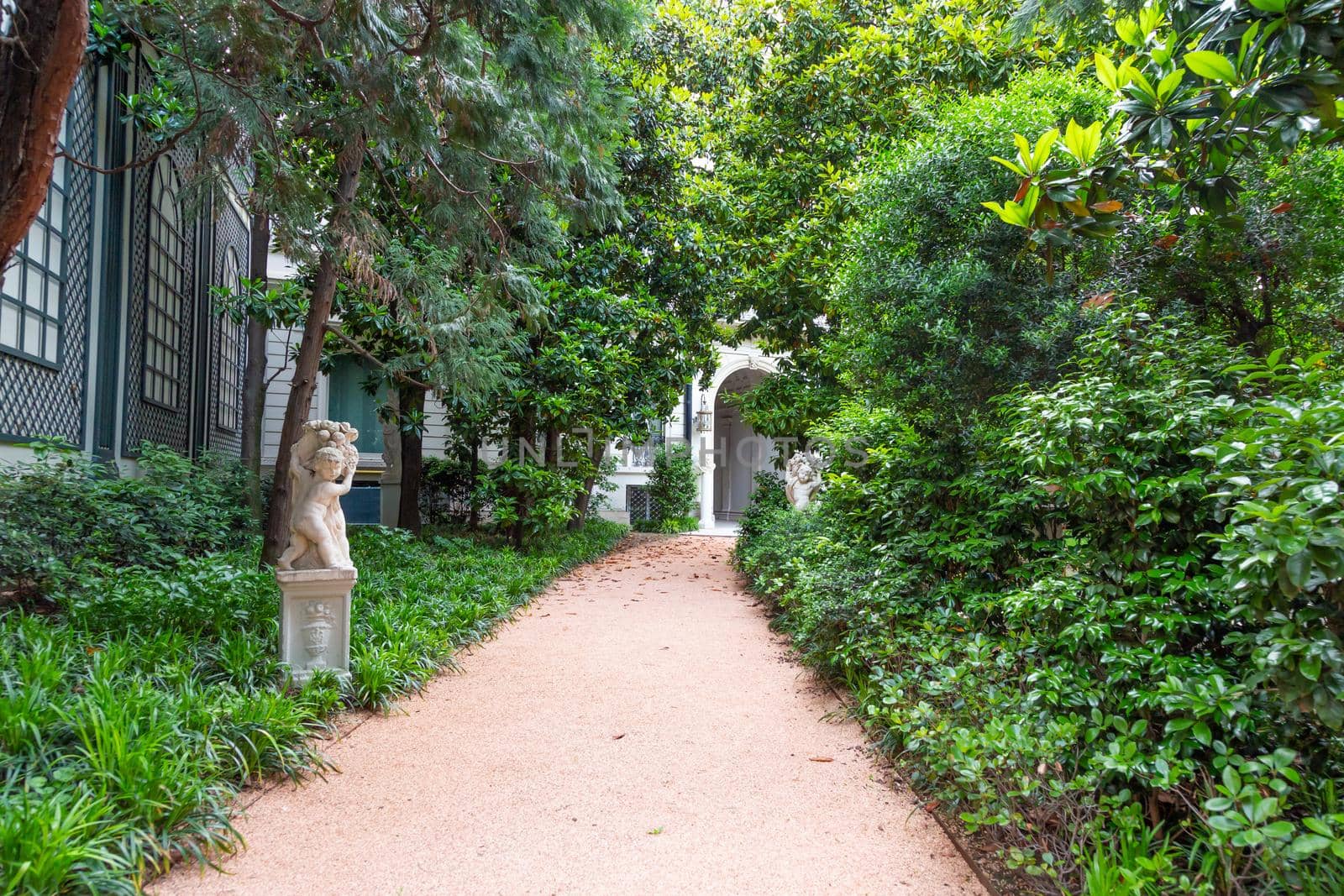 Milan, Italy - Circa June 2021: Italian Villa entrance with garden. Luxurious green exterior