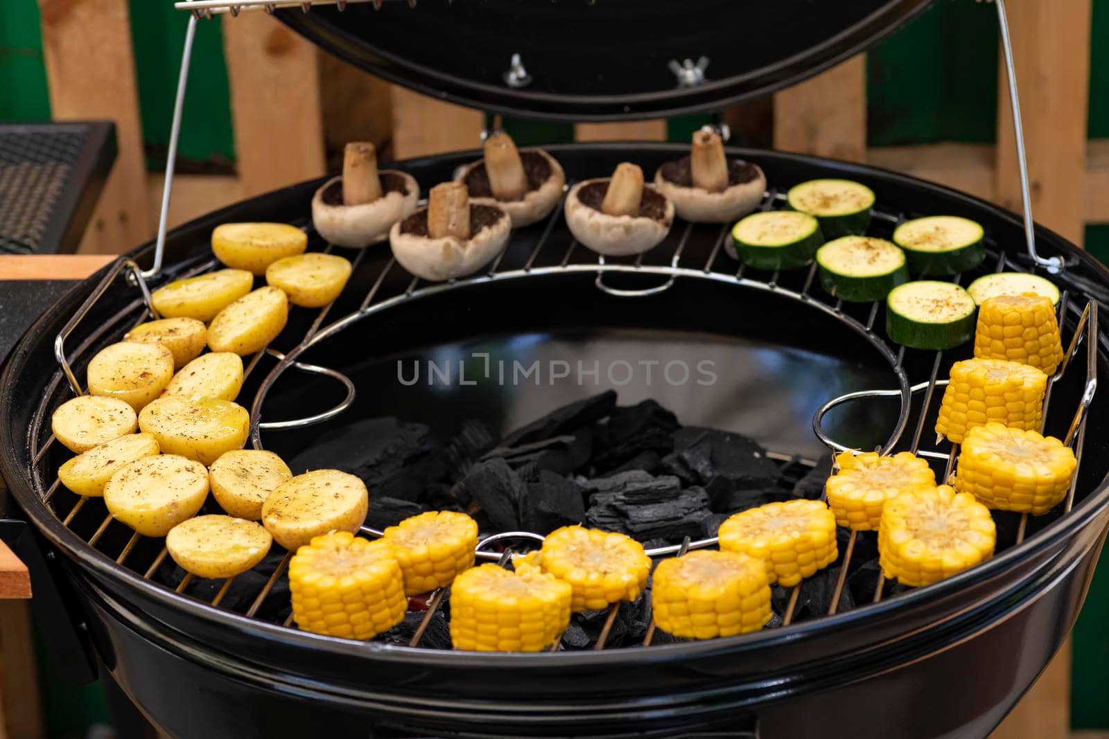 grill with potatoes, turkey meat, zucchini, mushrooms and sausages