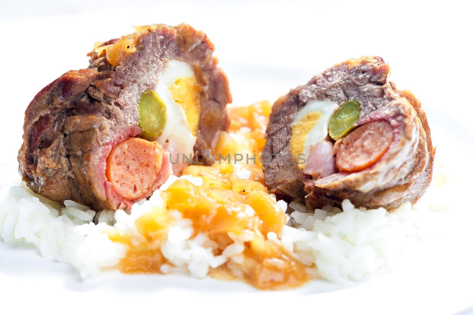 beef roulade filled with egg, sausage, bacon and prickle served with rice