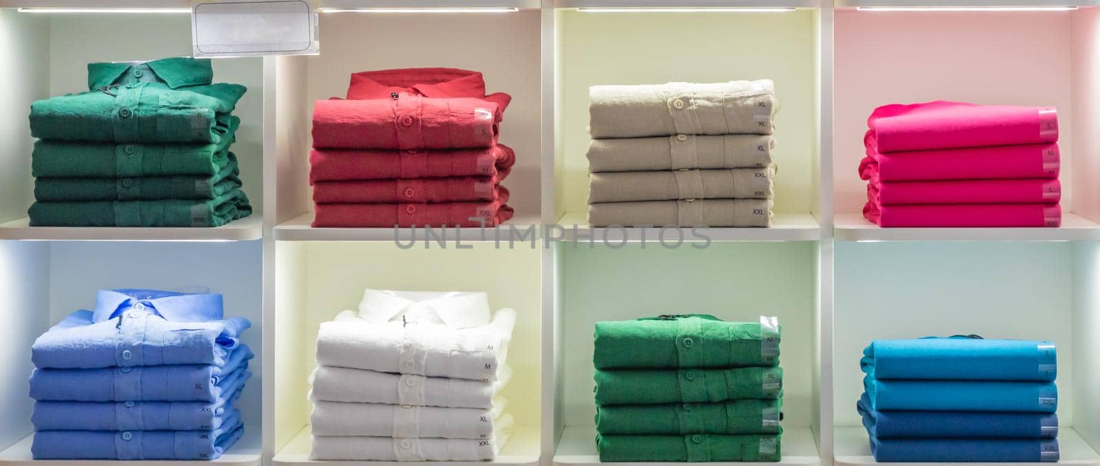 Polo t-shirt store interior. Shop shelves with  colored fashion cotton shirts.