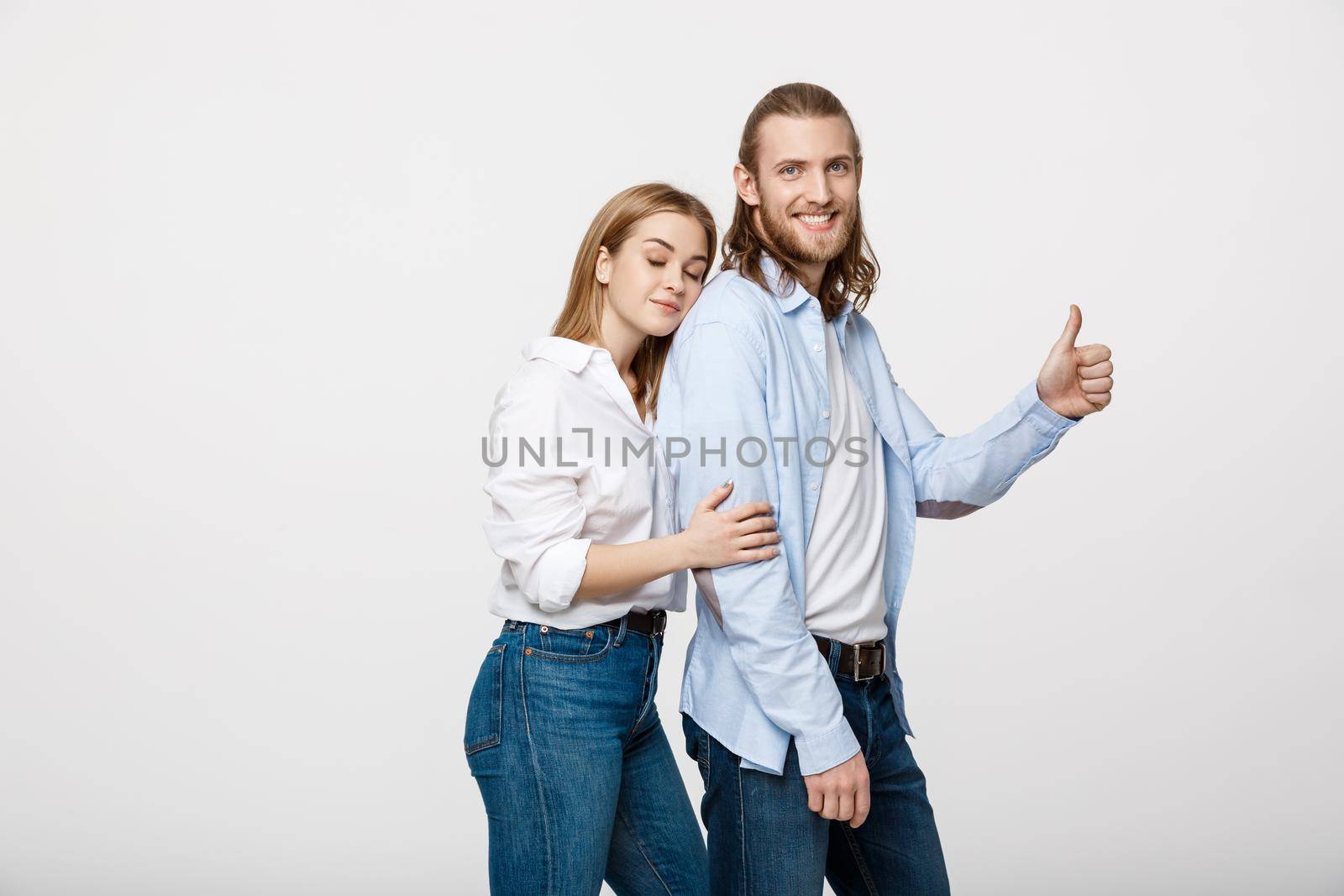 Portrait of Happy Young Couple Showing Thumb Up Isolated On White Background.