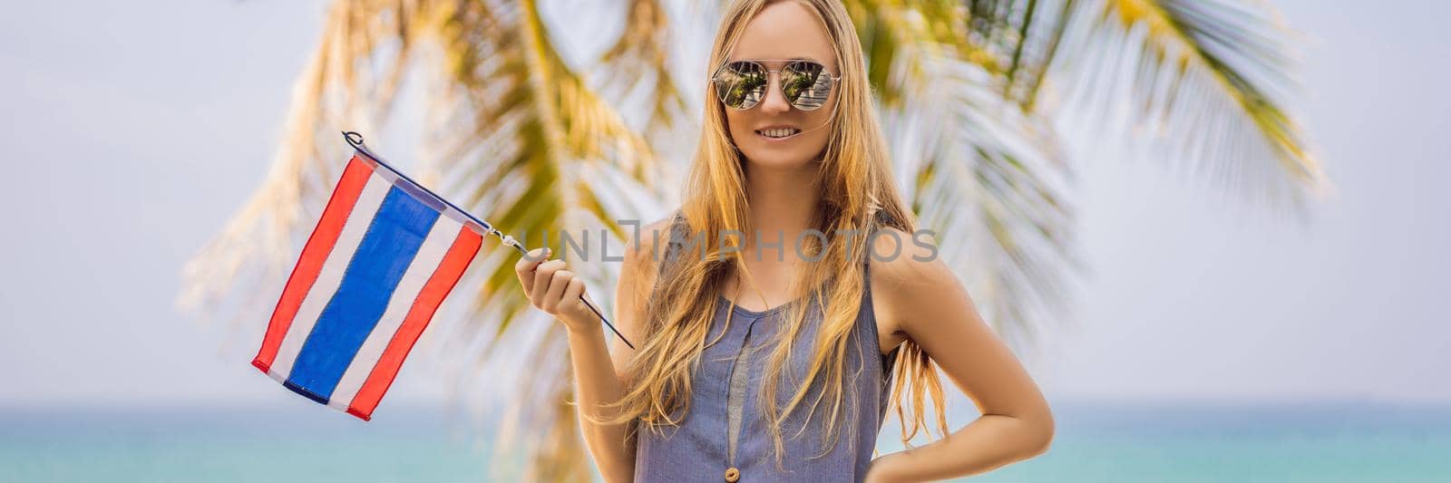 Happy woman having fun at the beach with Thailand flag. Beautiful girl enjoying travel to Asia. BANNER, LONG FORMAT