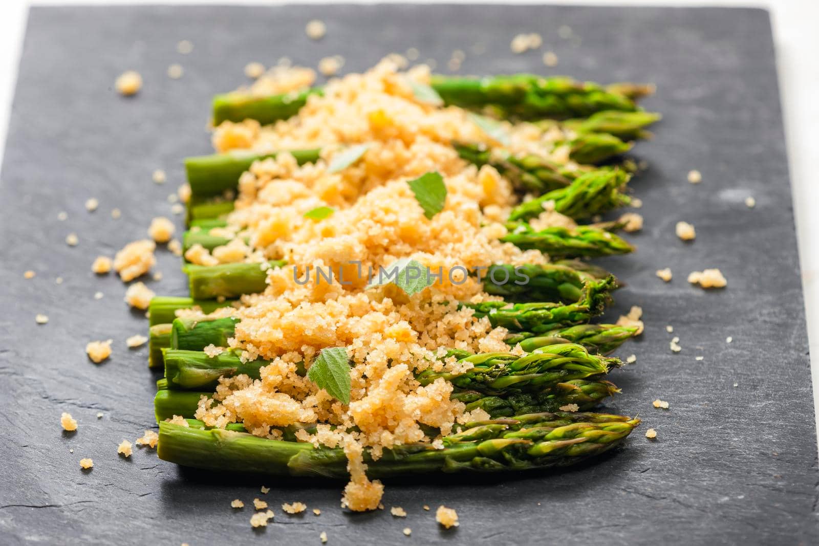 parmesan and breadcrumbs on green asparagus