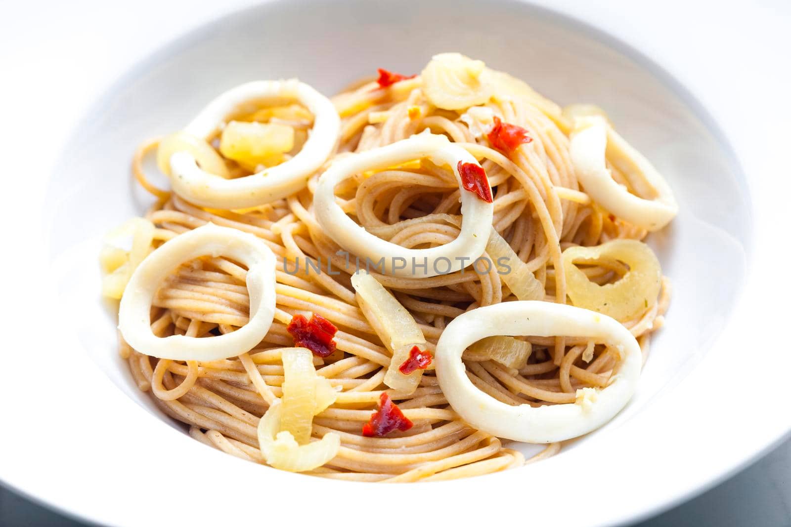 spaghetti with calamari, chilli pepper and onion