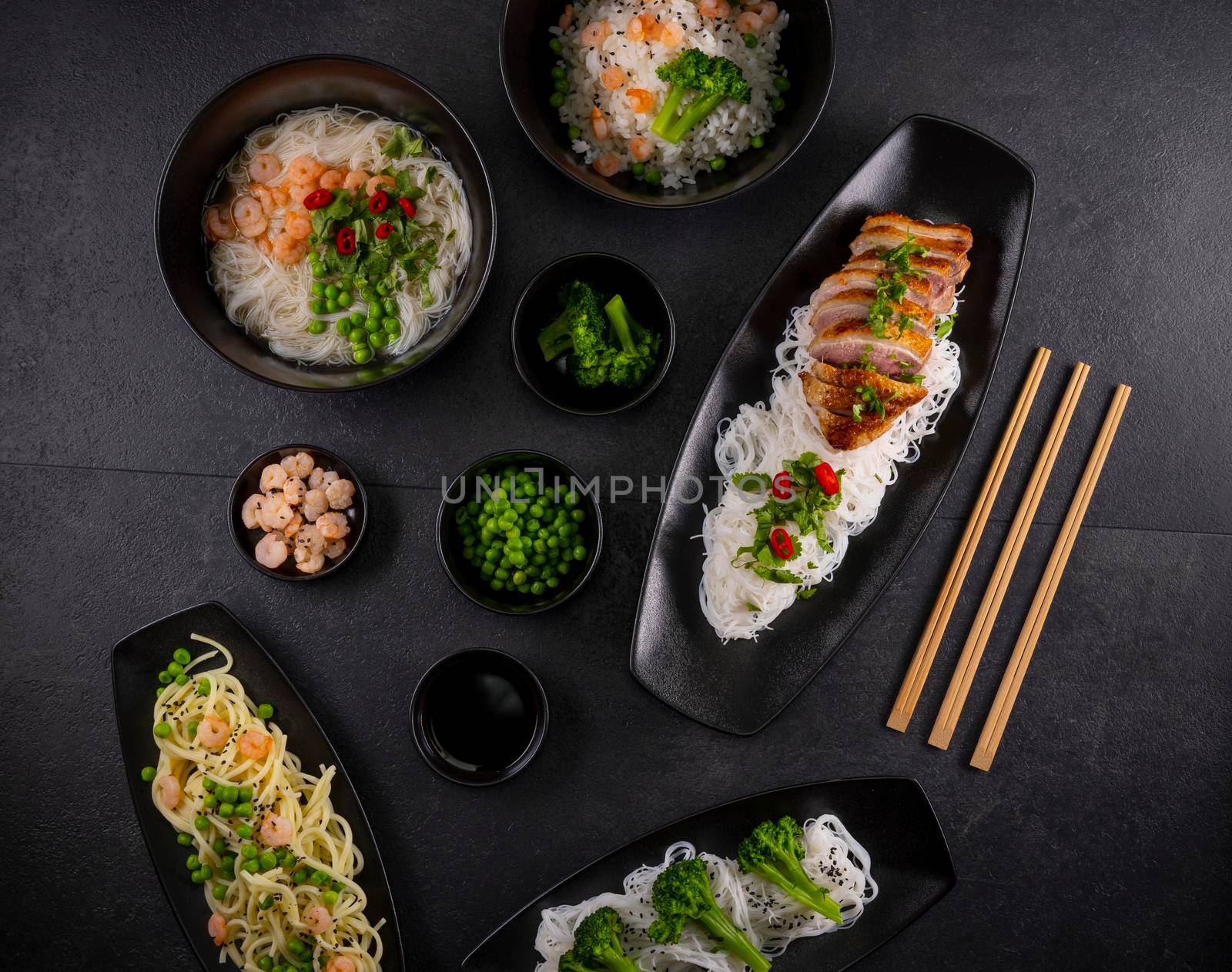 Various dishes of Asian cuisine with different types noodles and rice with shrimp, duck, vegetables and black sesame by phbcz