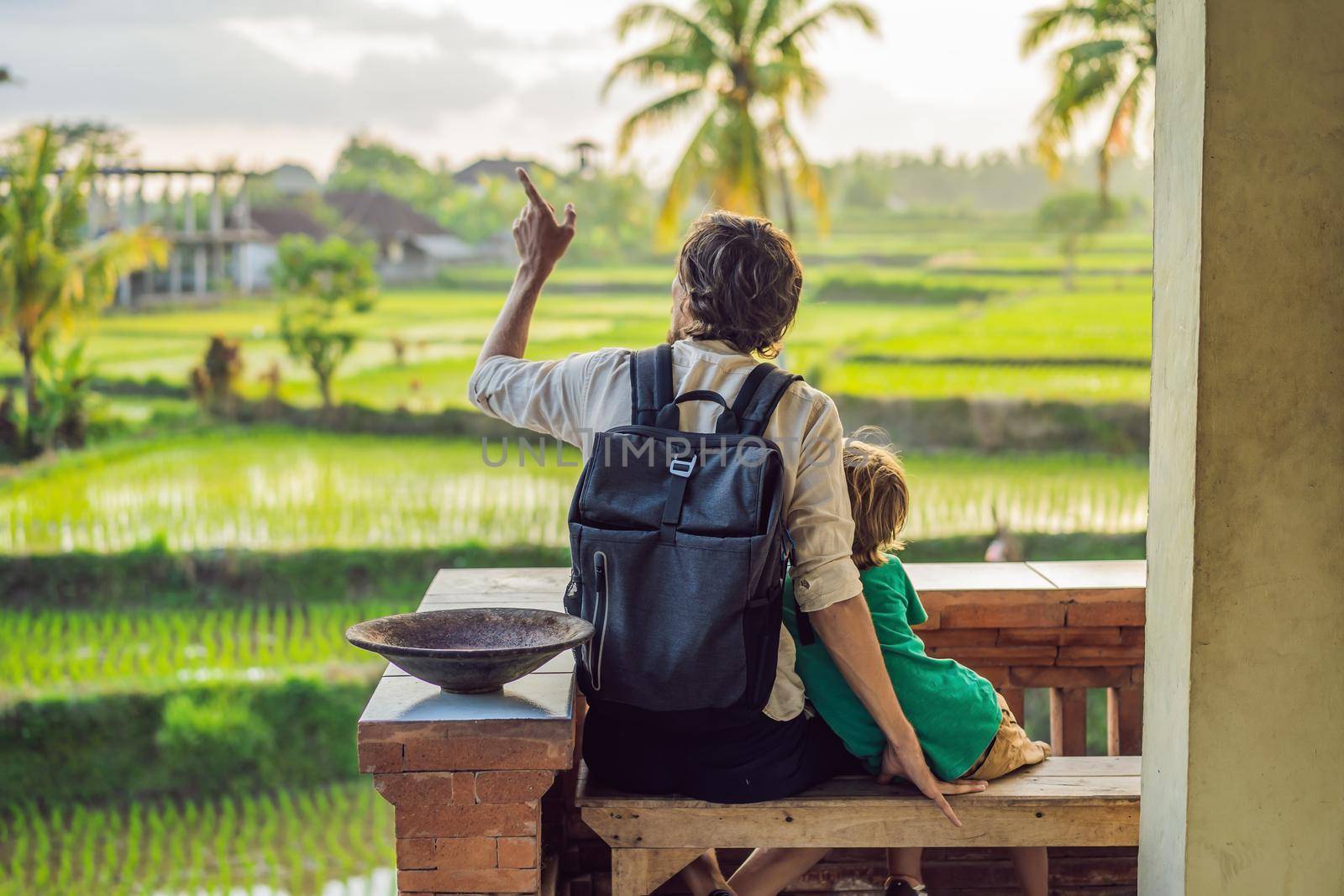 Dad and son travelers on Beautiful Rice Terraces against the background of famous volcanoes in Bali, Indonesia Traveling with children concept.