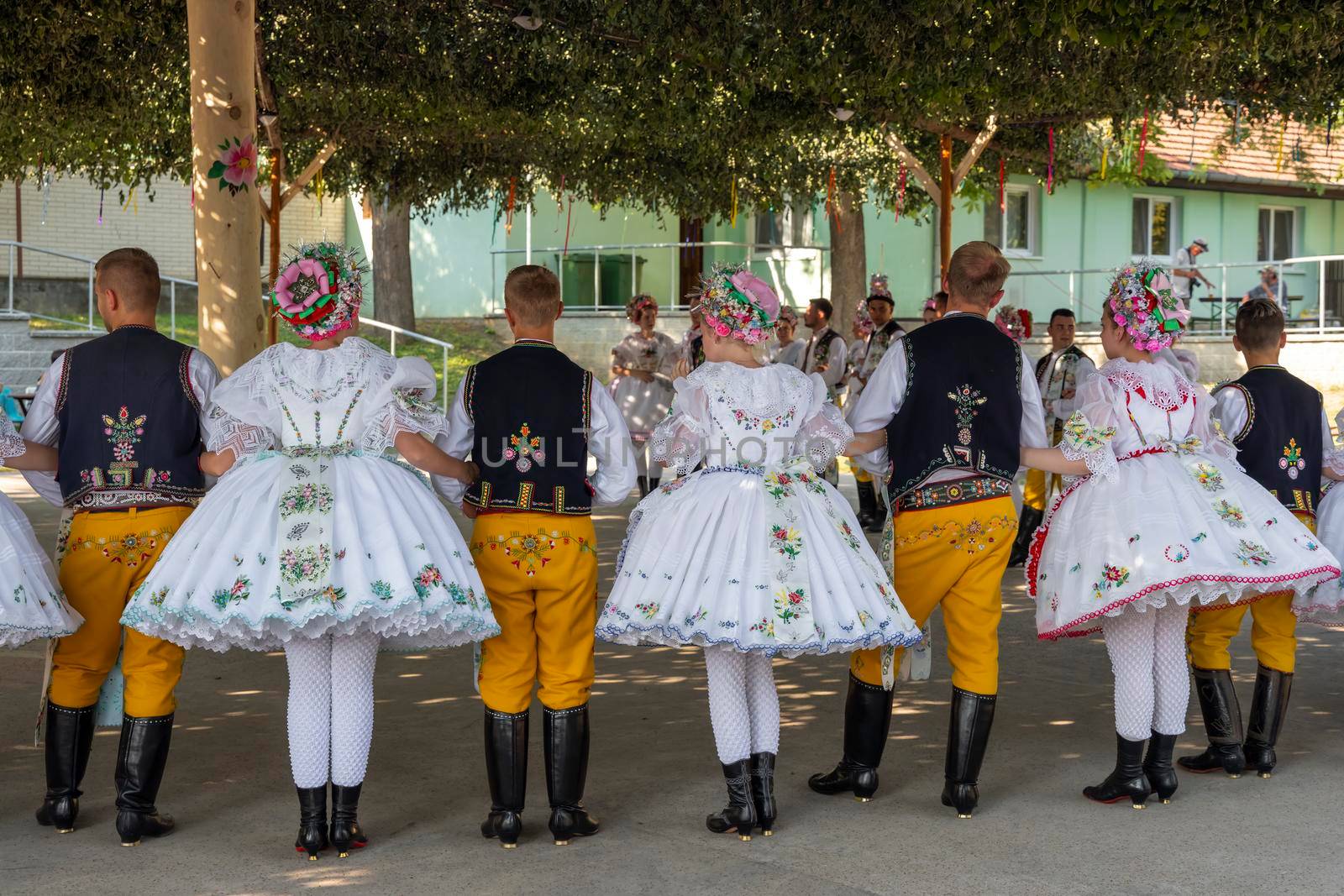 Rakvice, Czech Republic - June 2021. Beautiful women and men dancers in a celebration.Traditional Moravian feast. Young people in parade dressed in traditional Moravian folk costume.