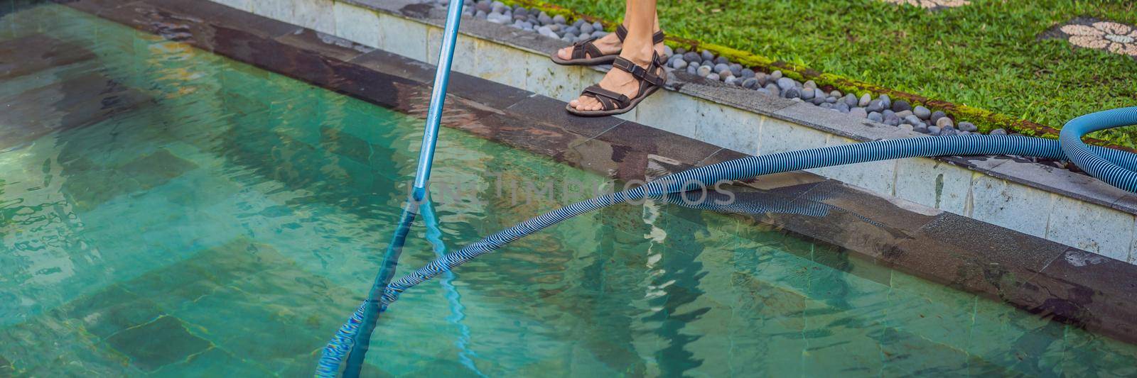 Cleaner of the swimming pool . Man in a blue shirt with cleaning equipment for swimming pools. Pool cleaning services BANNER, LONG FORMAT by galitskaya