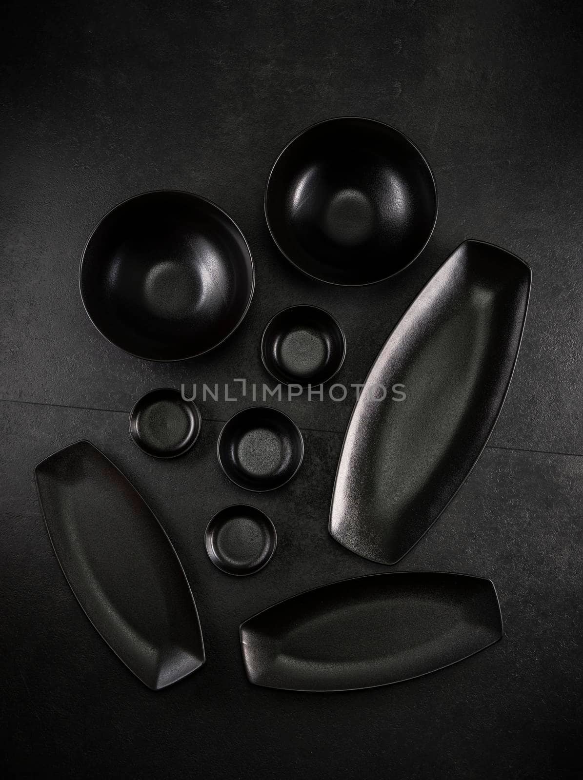 black plates and bowls on a black background by phbcz