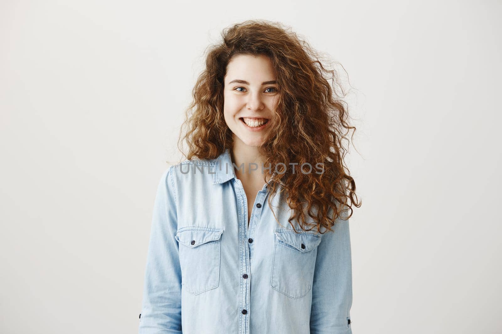 Close-up portrait of beautiful tender brunette woman looking , isolated on grey background.