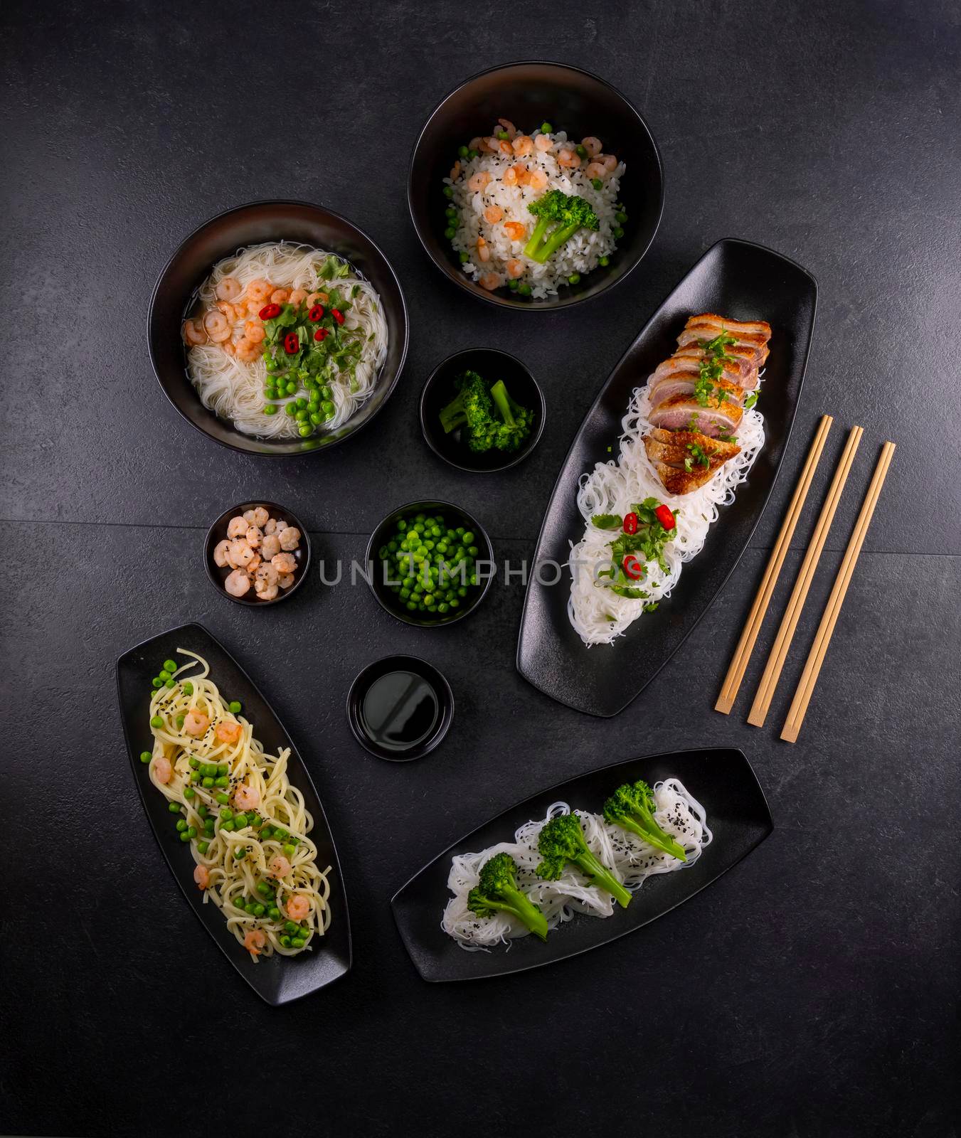 Various dishes of Asian cuisine with different types noodles and rice with shrimp, duck, vegetables and black sesame by phbcz