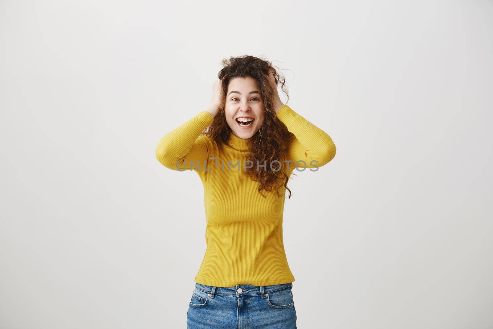 Portrait of beautiful cheerful redhead girl with curly hair smiling laughing looking at camera over white background