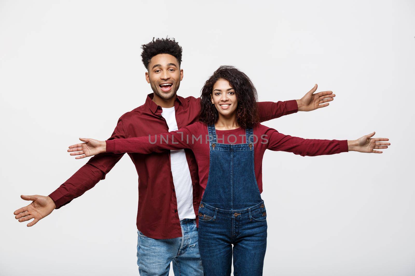 Happy young African couple dressed casually having fun together. by Benzoix