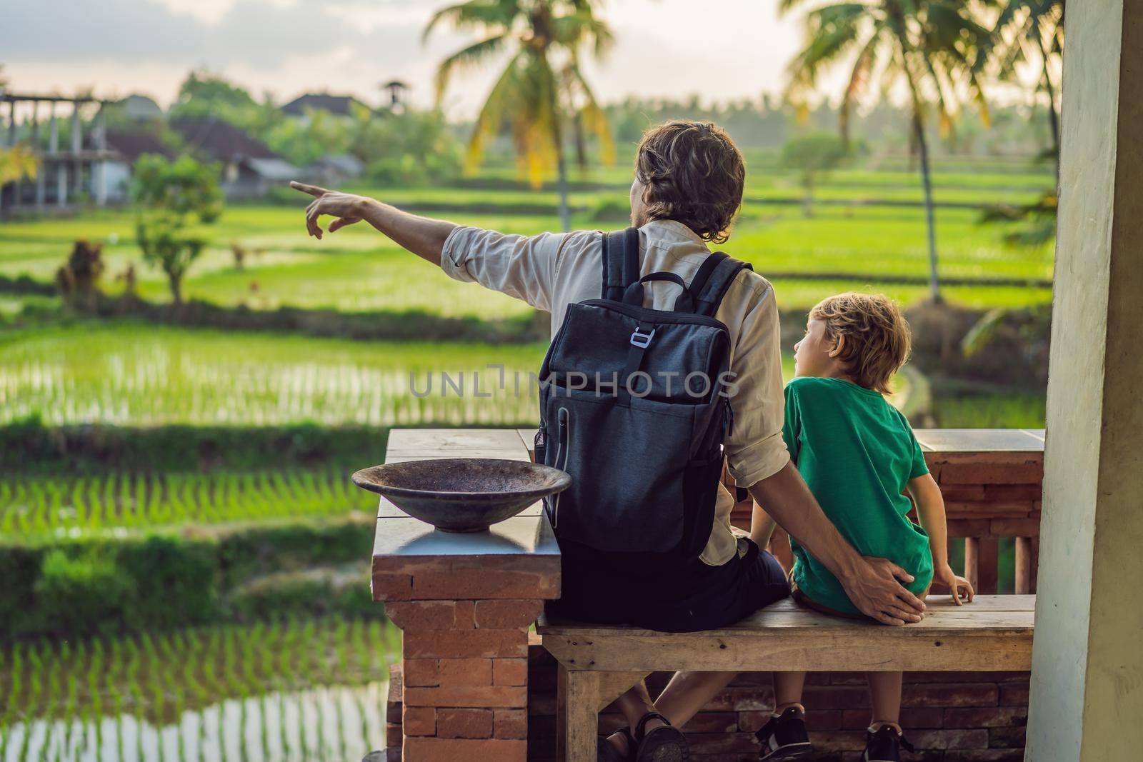 Dad and son travelers on Beautiful Rice Terraces against the background of famous volcanoes in Bali, Indonesia Traveling with children concept.