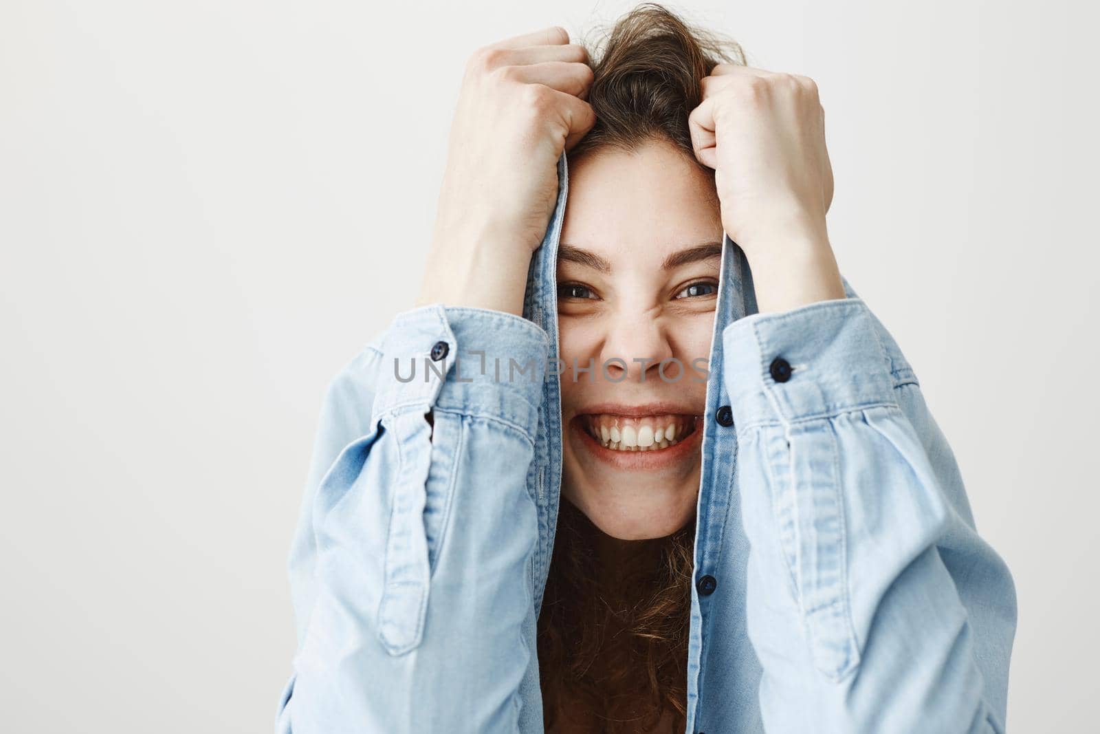 Surprised happy beautiful woman looking excitement. Isolated on gray background by Benzoix