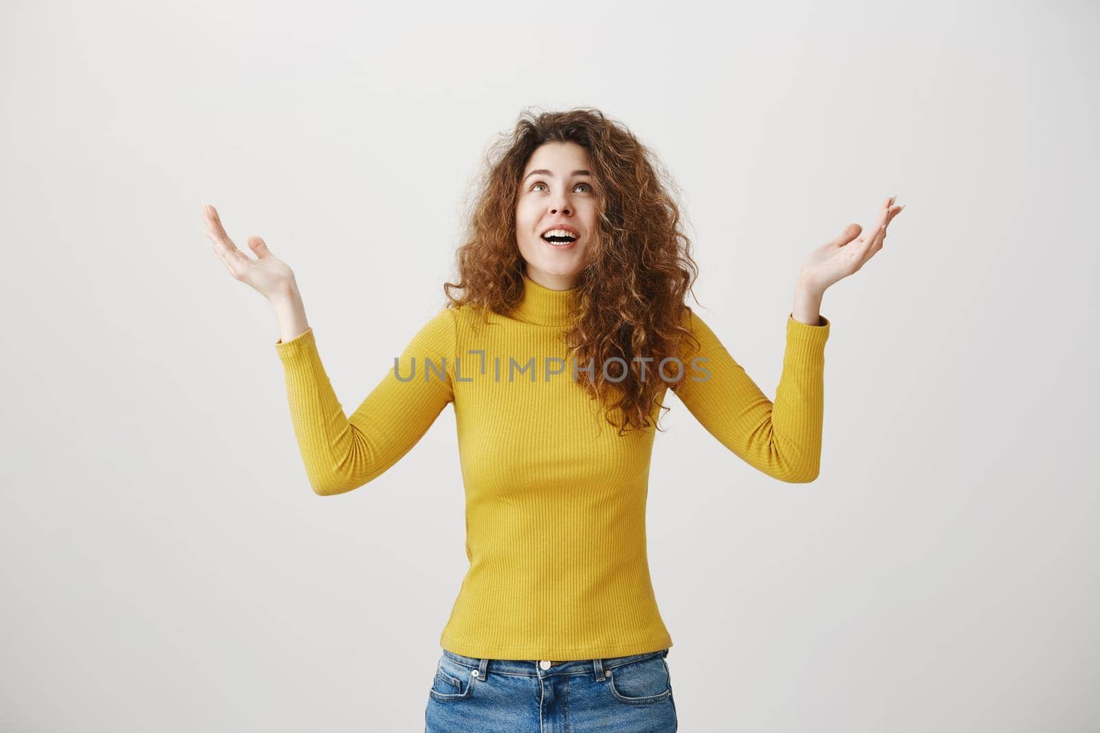 Portrait excited surprise young woman standing isolated over white background. Looking camera