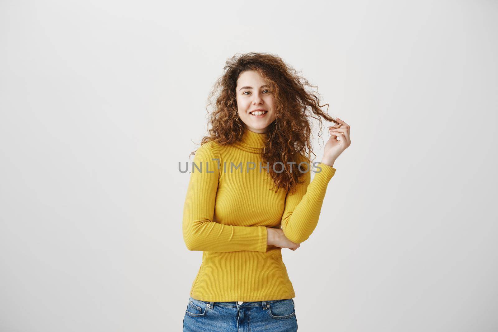 Portrait of beautiful cheerful redhead girl with curly hair smiling laughing looking at camera over white background