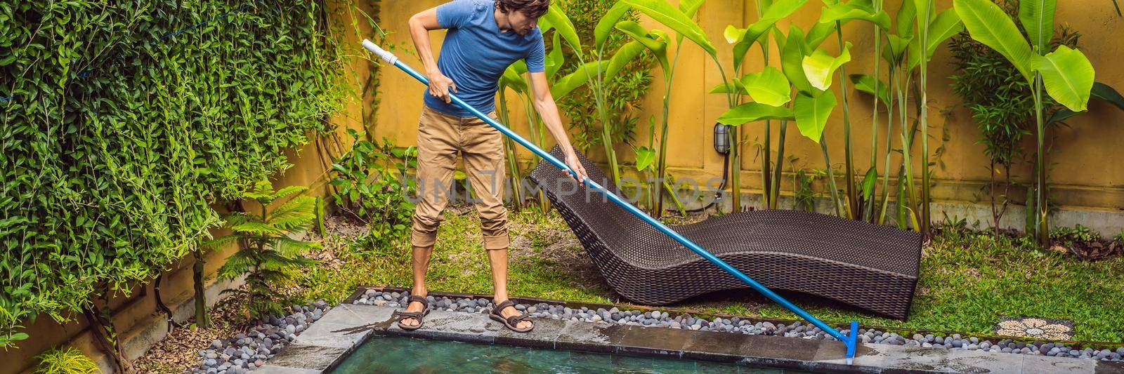 Cleaner of the swimming pool . Man in a blue shirt with cleaning equipment for swimming pools. Pool cleaning services. BANNER, LONG FORMAT