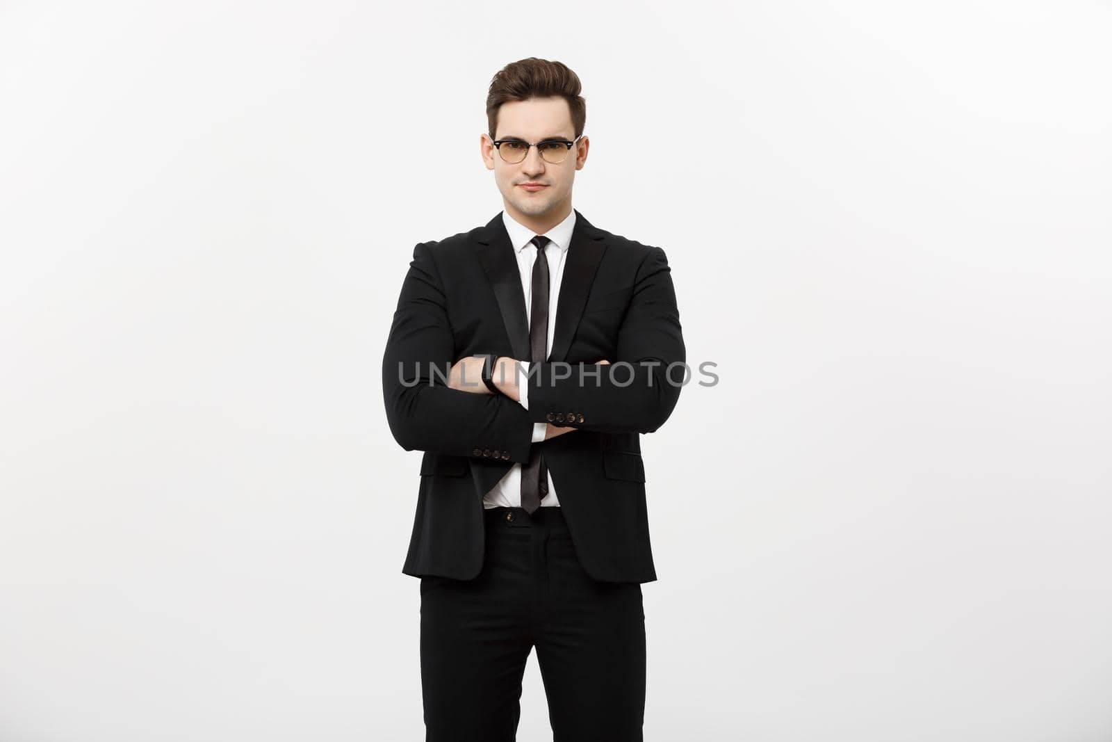 Happy businessman isolated - Successful handsome man standing with crossed arms isolated over white background