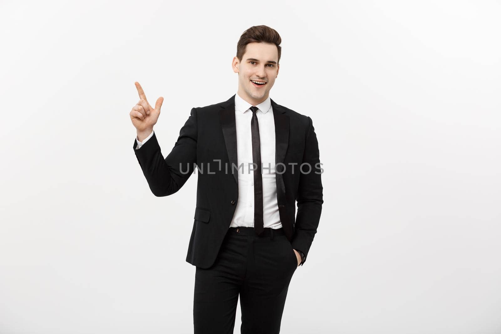 Business Concept: Handsome businessman with a finger pointed up isolated over white background.