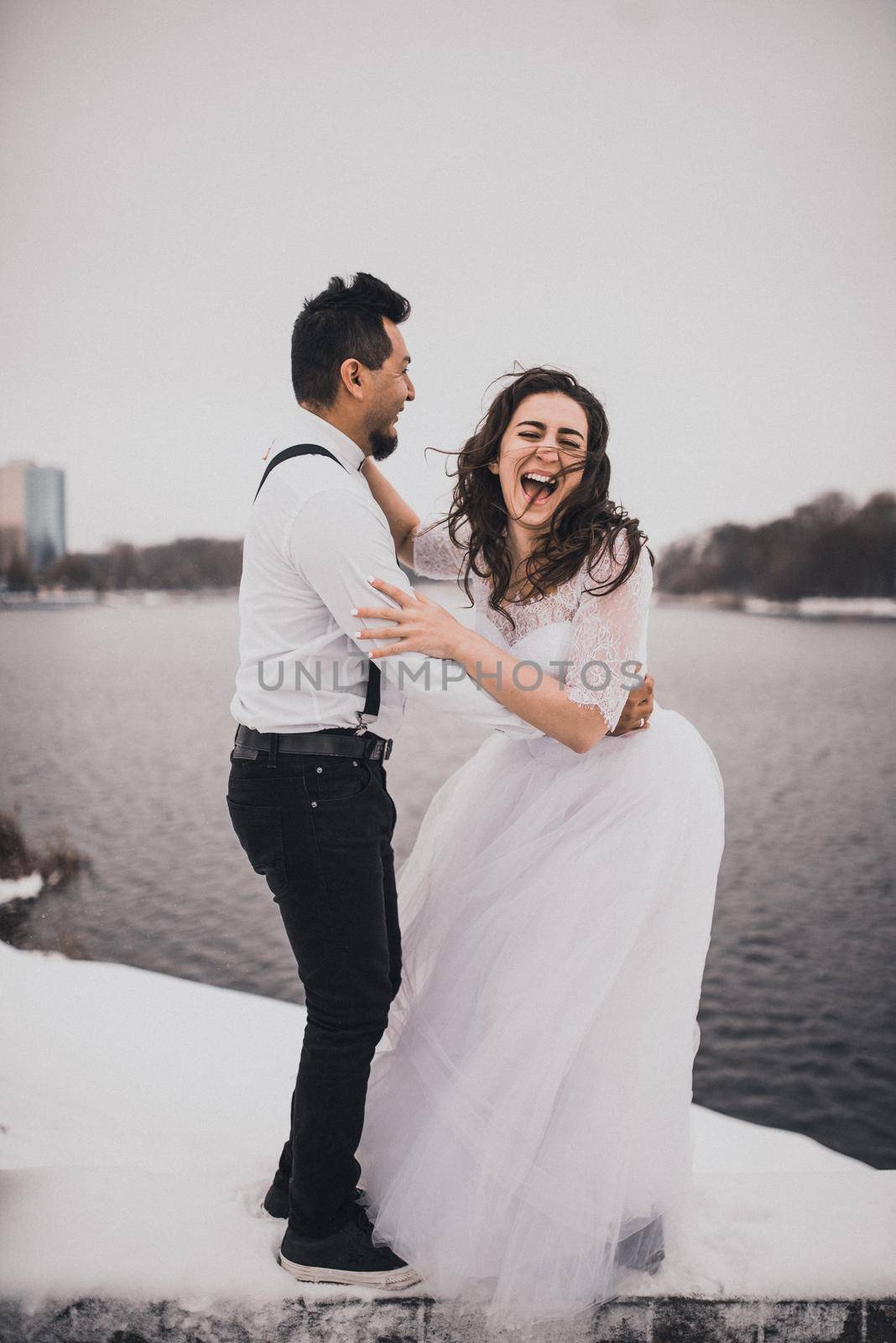 groom and bride wedding love couple in winter in snow by AndriiDrachuk