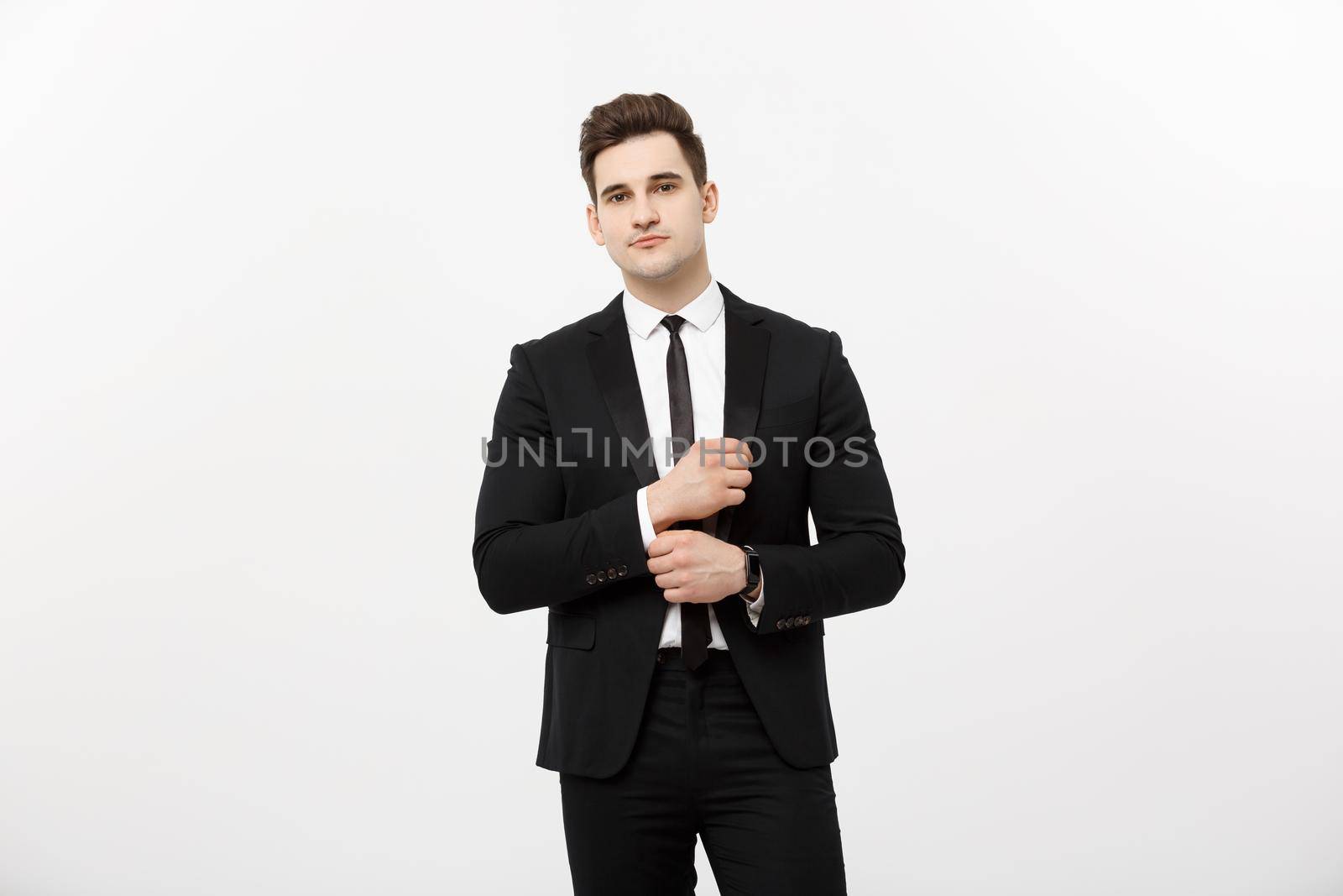Business Concept: Handsome Man Happy Smile Young Handsome Guy in smart suit posing over Isolated Grey Background