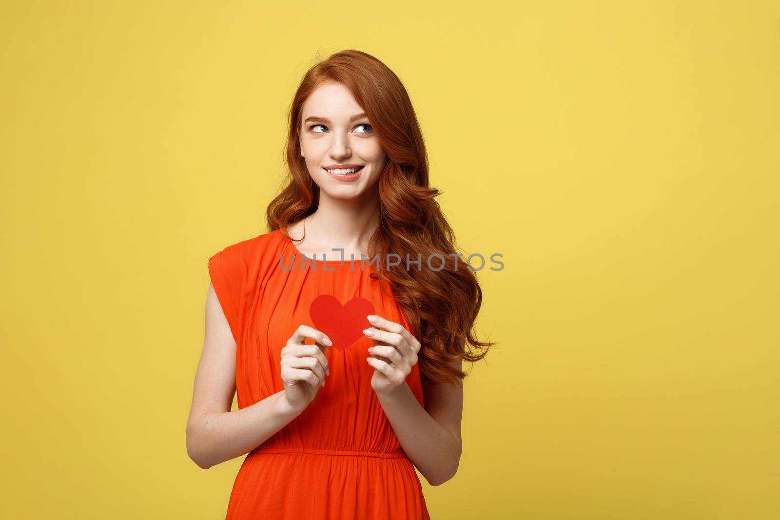 Portrait of happy romantic young caucasian girl with red paper heart-shaped postcard, romantic wishes, Valentine day celebration, love concept.