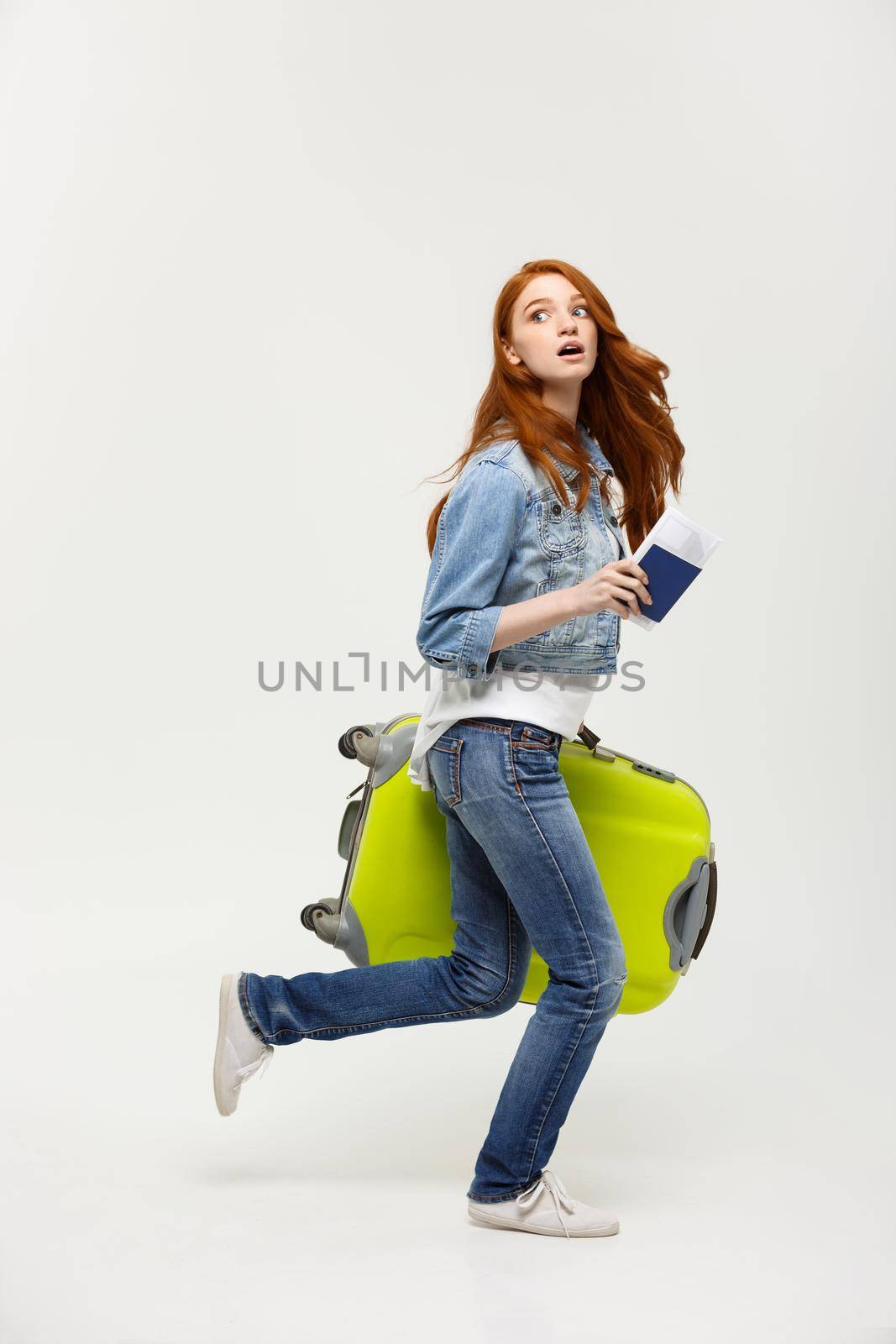 Travel and Lifestyle Concept - Portrait woman holding and running with a large suitcase and passport to vacation.