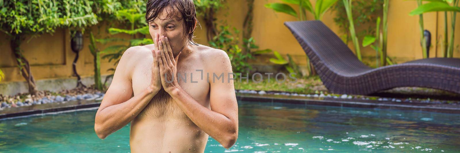 BANNER, LONG FORMAT Young man with disgust on his face pinches nose, something stinks, very bad smell in swimming pool because of pool chemicals. Negative emotion facial expression by galitskaya