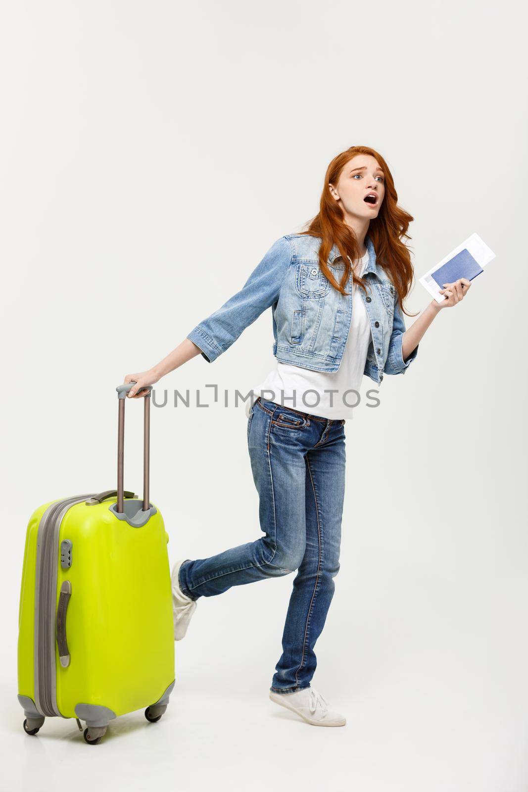 Travel and Lifestyle Concept: young woman with suitcase ready for summer travel isolated on white.
