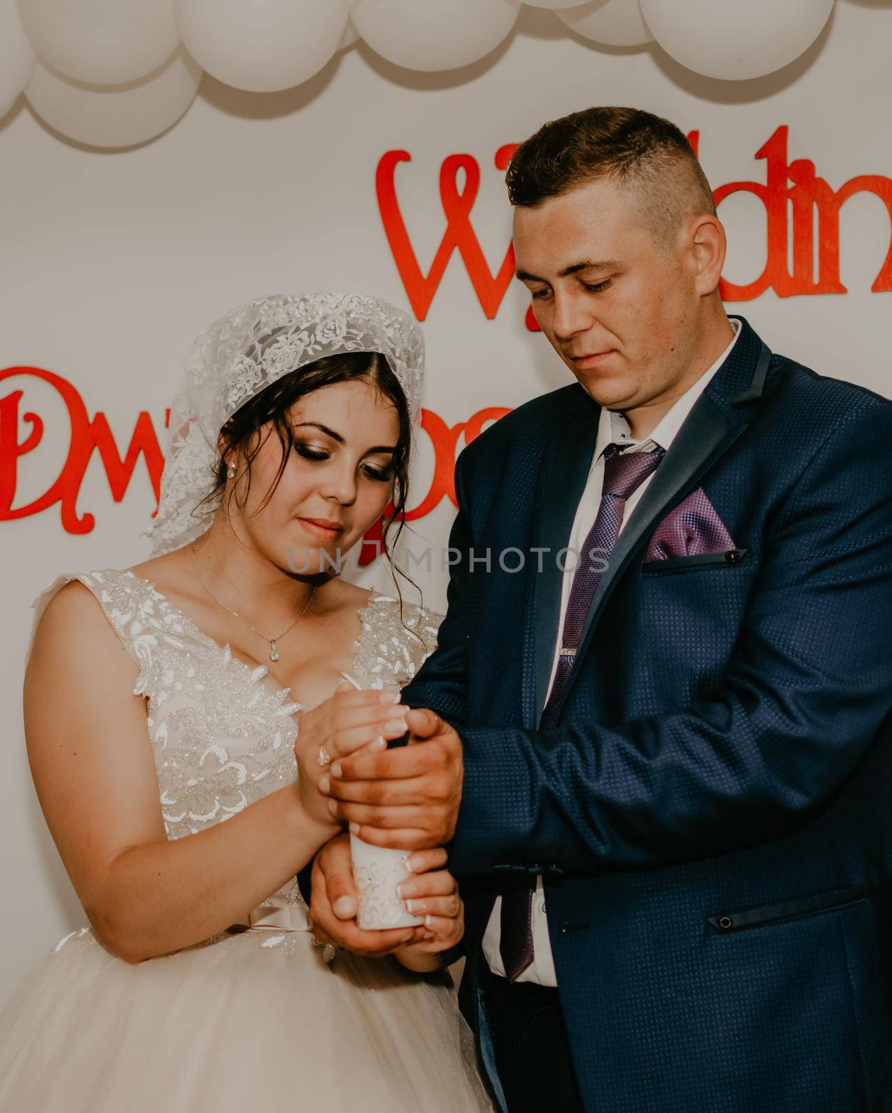 groom and the bride shawl are holding together in their hands a lighted candle, which symbolizes the family hearth. Slavic Ukrainian Russian wedding traditions