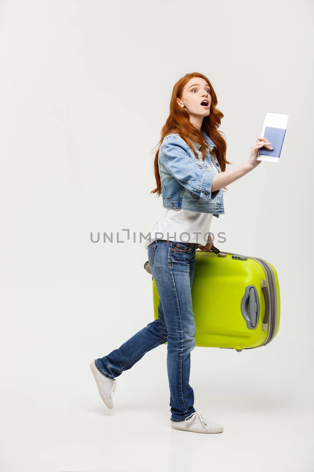 Travel Concept: Young Caucasian Woman traveler with suitcase isolated on white background