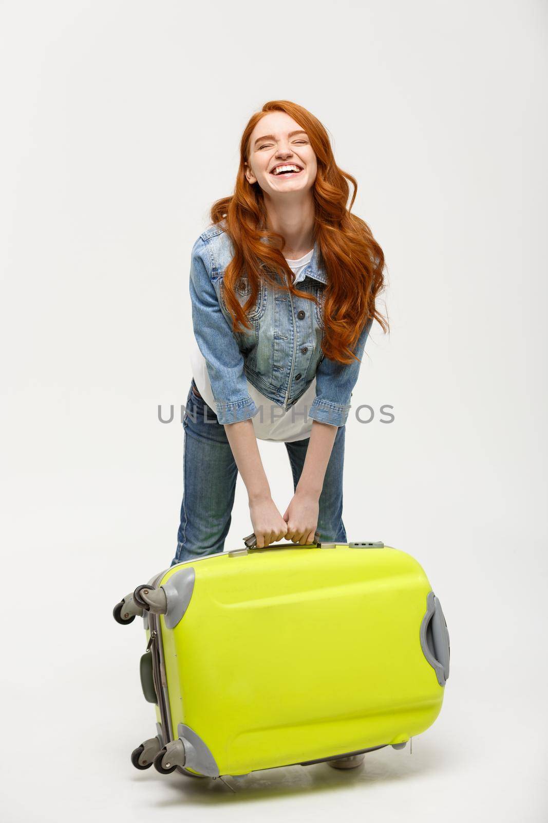 Travel and Lifestyle Concept: Young happy beautiful woman holding green suitcase over white background by Benzoix