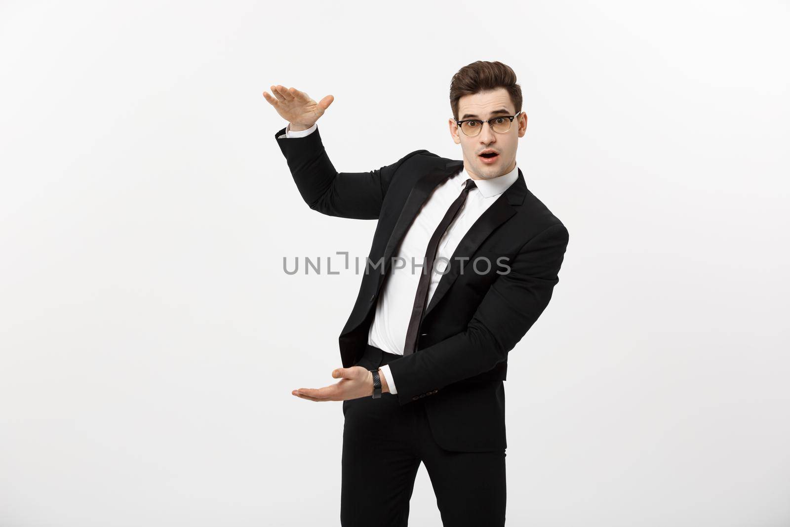 Handsome young business man happy smile, businessman showing something on the open palm, concept of advertisement product isolated over white background