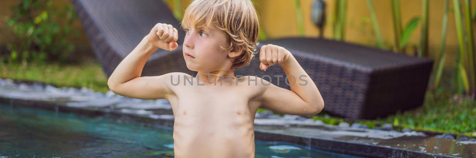 A boy shows his muscles after swimming BANNER, LONG FORMAT by galitskaya