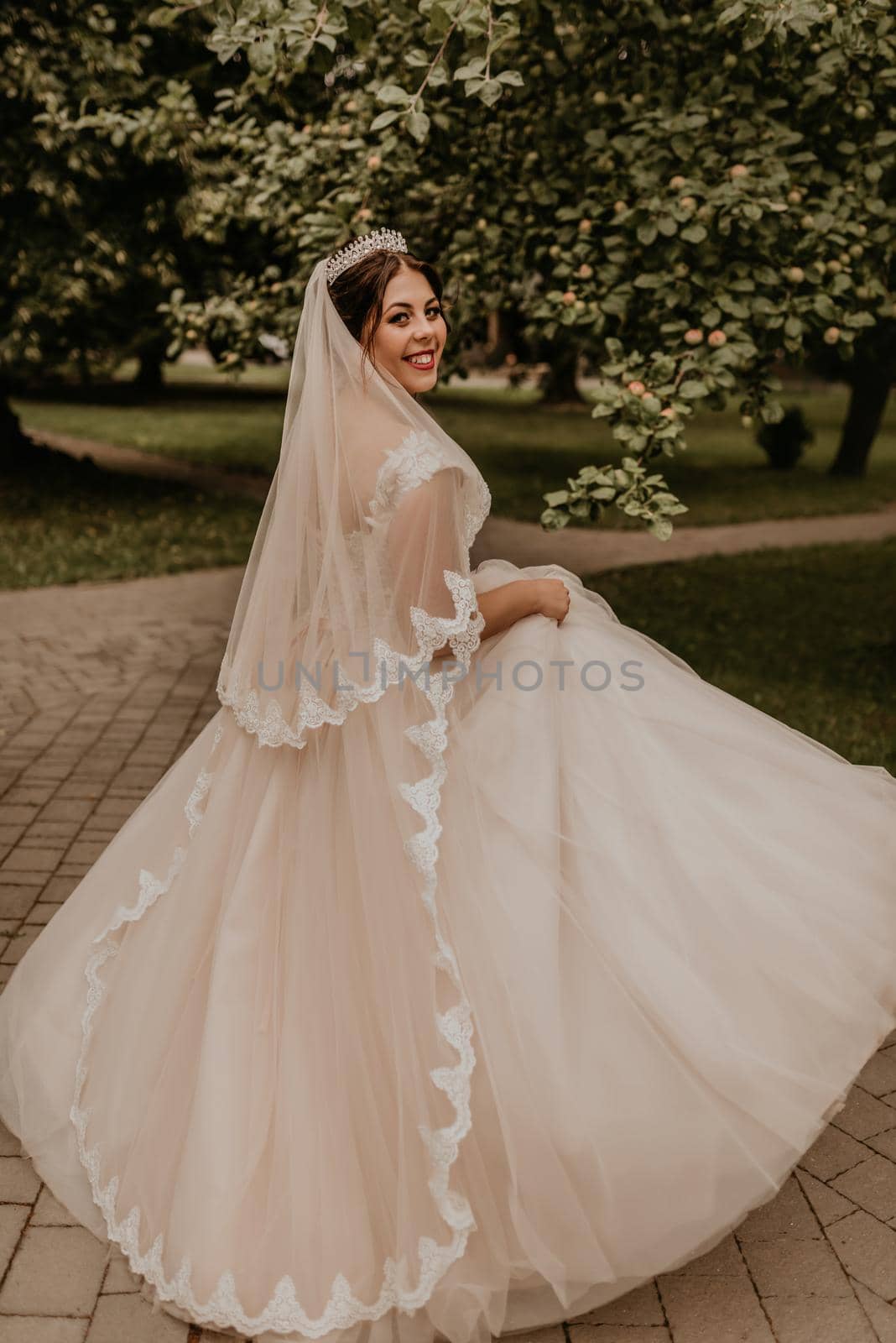 Caucasian young woman bride spinning whirls dancing posing moving at nature by AndriiDrachuk
