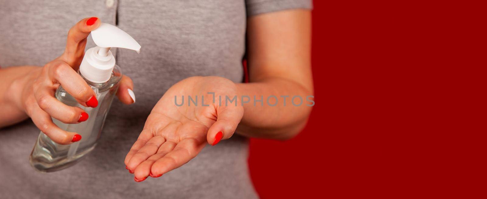 A woman uses a gel, disinfectant, antiseptic. Hand sanitizer prevents viral and plague infections, prevents the appearance of the Covid-19 virus.